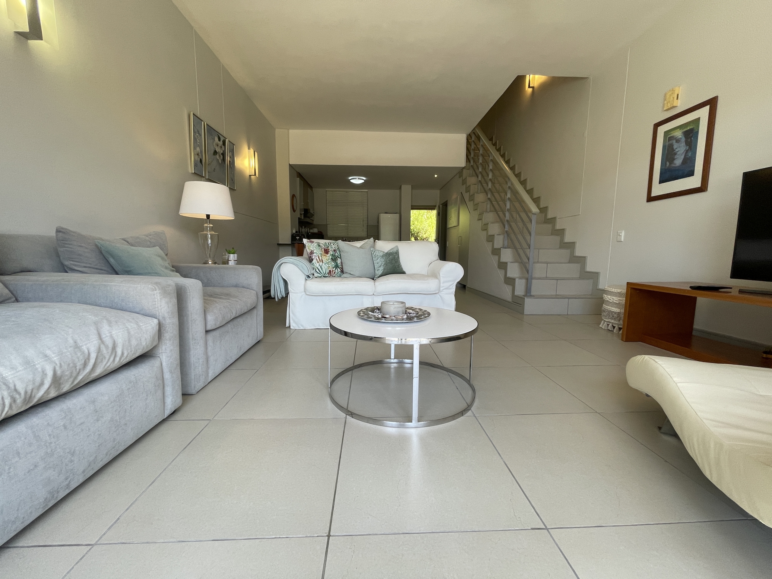 Open plan living area with stairs leading to bedrooms on second floor