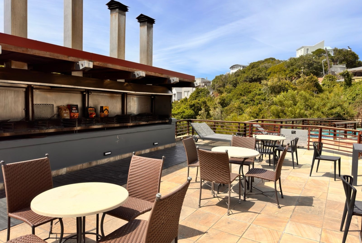 Communal braai and swimming pool area at The Herolds Bay Luxury Apartment building