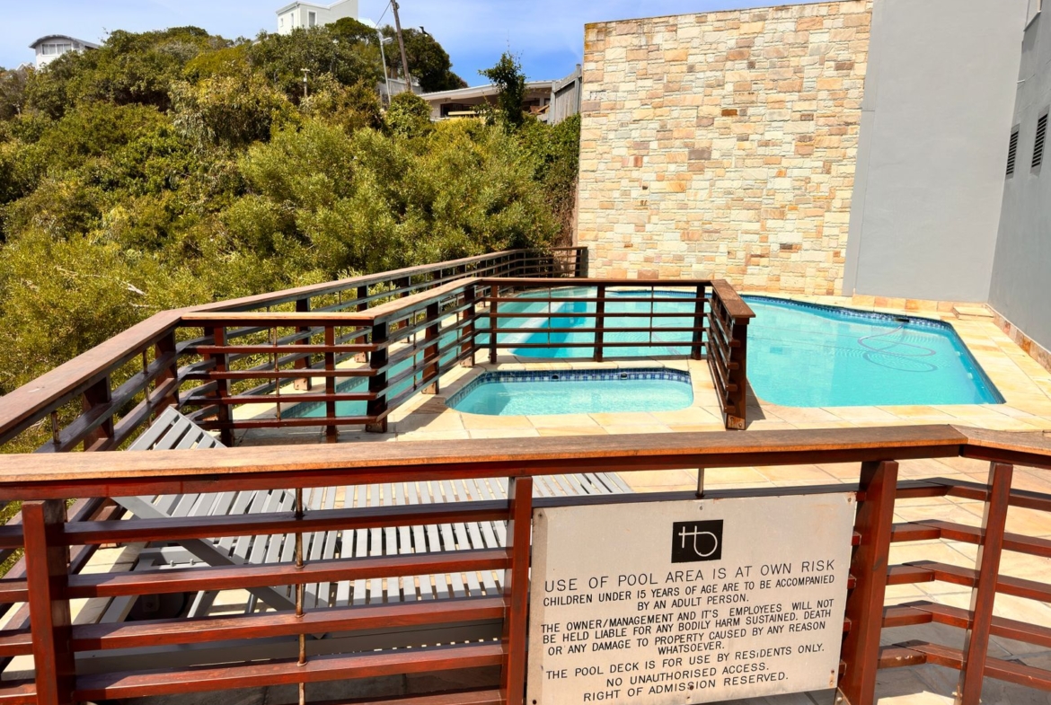 Communal braai and swimming pool area at The Herolds Bay Luxury Apartment building