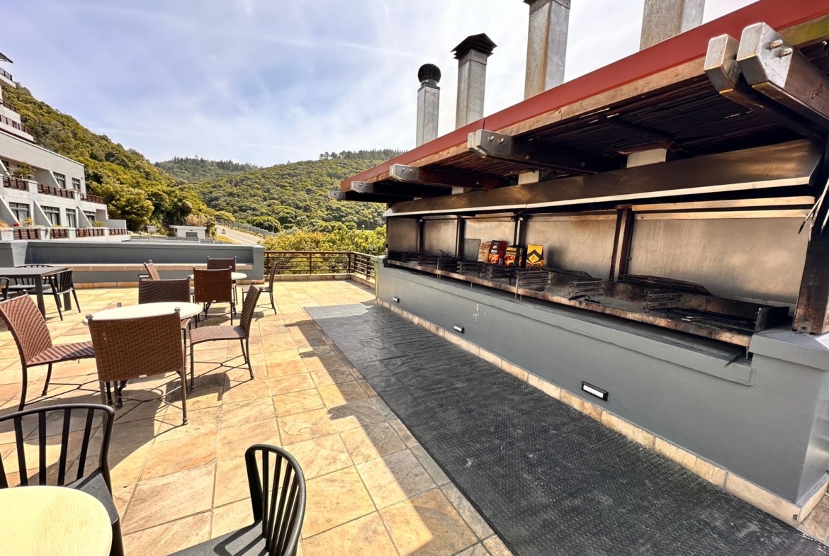 Communal braai and swimming pool area at The Herolds Bay Luxury Apartment building